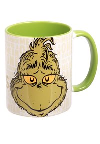 Tazza in ceramica con un'illustrazione del Grinch verde su uno sfondo crema e testo chiaro. Il manico e l'interno sono di un verde brillante.
