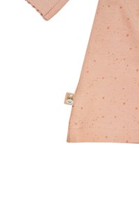 Helles rosa Kurzarmhemd mit feinen Sprenkeln, aus Baumwolle gefertigt. Hat einen gestickten Saum und ein kleines Etikett mit einem Cartoon-Tiergesicht.