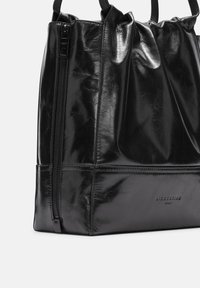 Schwarze Lederhandtasche mit glänzender Textur, gerafftem Design und seitlichem Reißverschluss. Mit einem dezenten eingeprägten Markenlogo auf der Vorderseite.