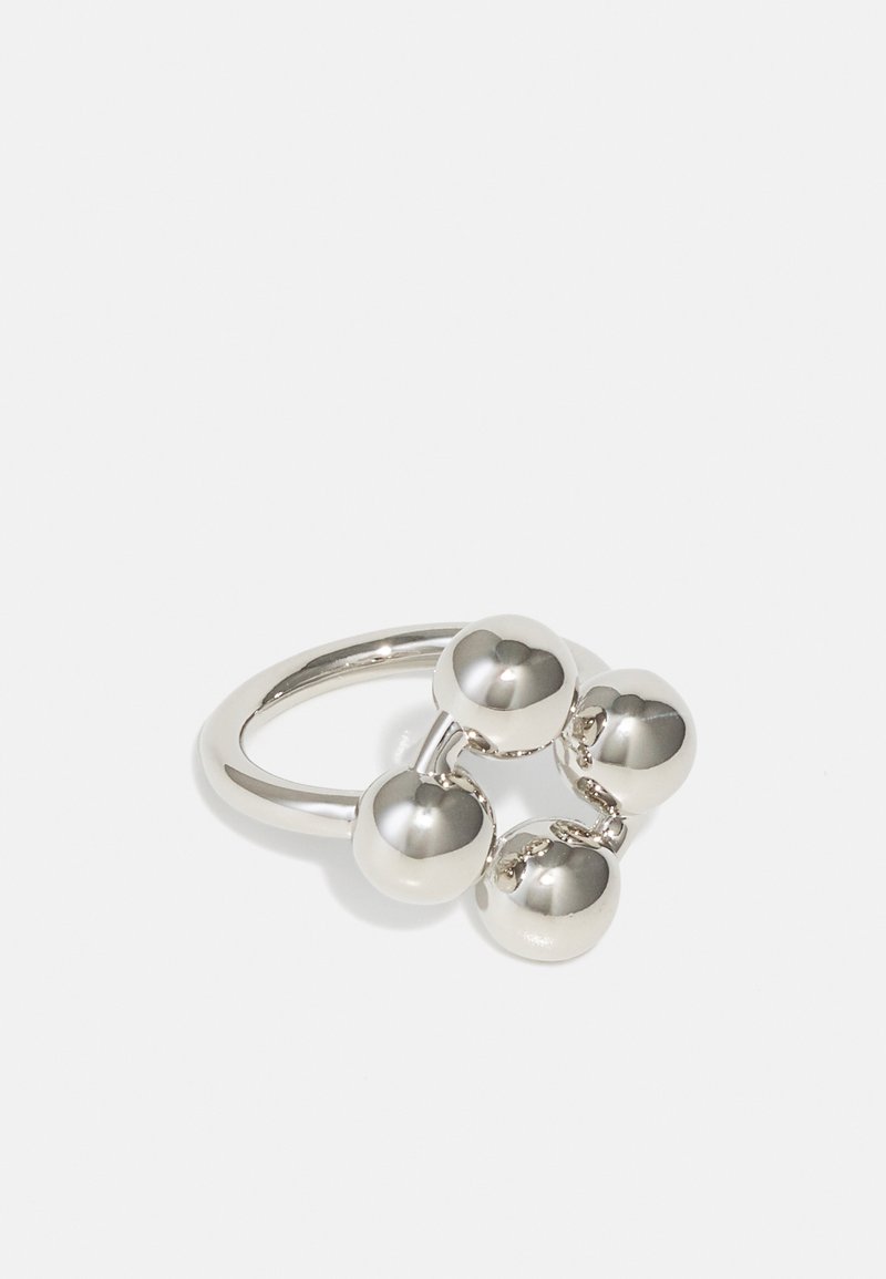 Silver metal ring featuring four spherical accents. Smooth finish with a polished texture. Simple, rounded design with interconnected elements.