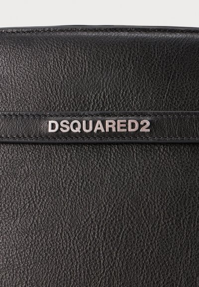 Black leather bag featuring a front panel with embossed “DSQUARED2” branding. The texture is grainy with visible stitching details.