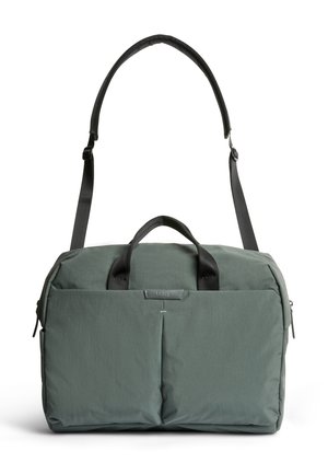 Sac de sport vert en softshell avec deux poches avant, poignées courtes et sangle d'épaule rembourrée réglable.