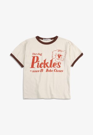 Cremefarbenes Kleinkind-T-Shirt mit braunem Rand, rotem Text "The dog Pickles since 09 Bobo Choses" und einer einfachen Linienzeichnung eines Hundegesichts.