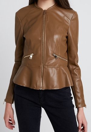 Brown fitted leather jacket with front zipper, two diagonal zippered pockets, and peplum hem worn with black pants.