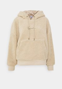 Béžový mikina s kapucňou z fleece s textúrovaným vonkajším povrchom, prednou vreckom a šnúrkami. Mäkka tkanina s rebrovanými manžetami a lemovaním.