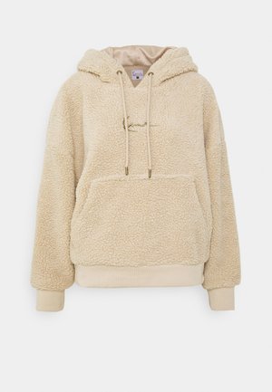 Beige hette fleece genser med en teksturert overflate, frontlomme og snorer. Myk stoff med ribbestrikkede mansjetter og søm.