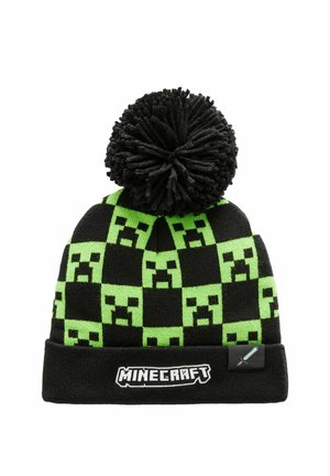 Musta ja vihreä neulottu pipo, jossa on ruutukuviota ja Minecraftin creeper-naamojen kuvioita, mustalla pom-pomilla päällä ja logotarralla.