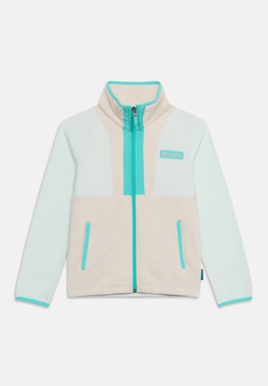 Veste polaire beige et bleu clair avec zip intégral à l'avant, col montant, deux poches zippées et détails de bordure turquoise.