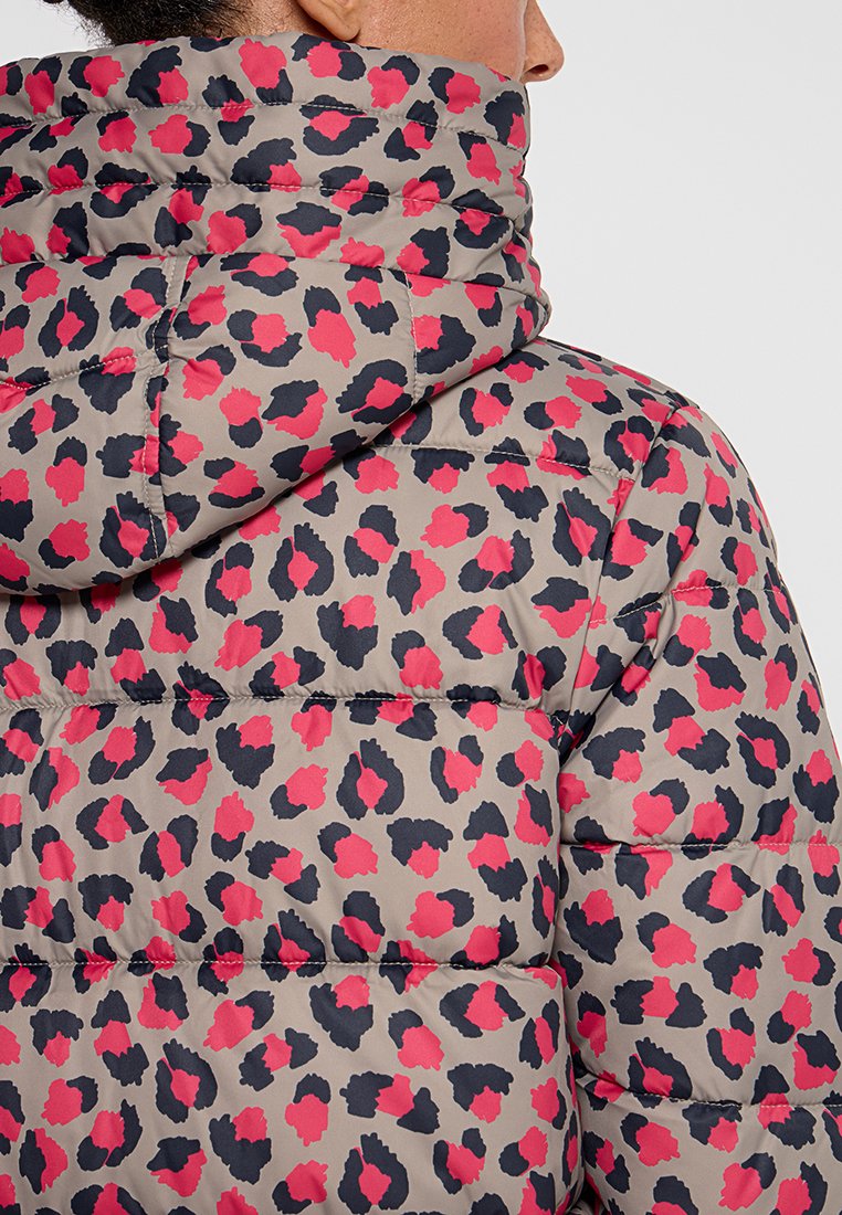 Padded jacket z wysokim kołnierzem, z jasnobeżowym tłem i wzorem w panterę w odcieniach różu i czerni. Teksturowany, pikowany design.