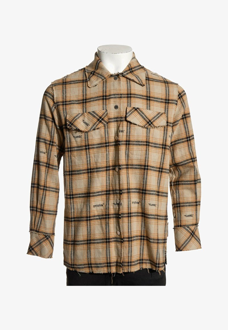 Chemise en flanelle à carreaux beige et noir avec boutons sur le devant, deux poches poitrine et les inscriptions "Off-White" et "Flannel" imprimées sur l'ensemble.