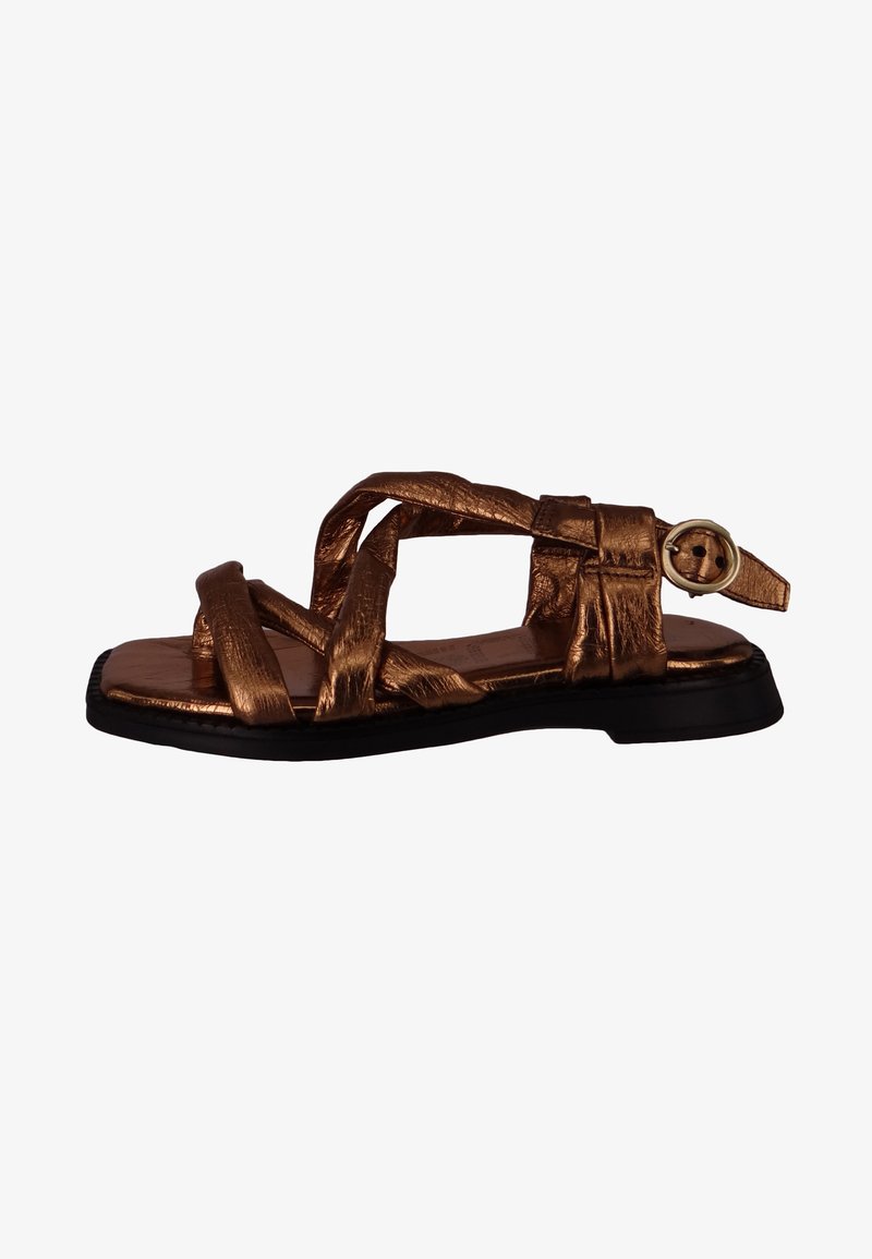 Bronze-colored sandal with woven straps, a flat black sole, and a round gold buckle accent on the ankle strap. Smooth texture throughout.