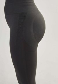 Schwarze Sportleggings mit einem strukturierten Muster an der Seite, hohem Bund und konturiertem Design zur Formverbesserung.