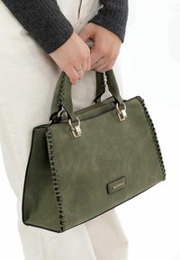 Green faux leather handbag with braided detailing, silver hardware, and top handles. Features a structured shape and zip closure.