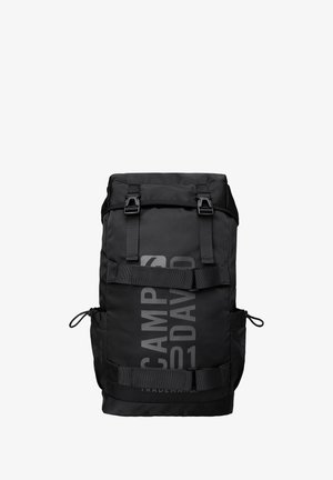 Black roll-top backpack made of durable fabric. Features adjustable straps, mesh side pockets, and a prominent logo printed on the front.