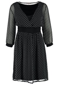 Robe midi noire à pois blancs, manches trois-quarts transparentes, col en V, taille cintrée et jupe fluide.