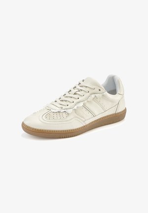 Light beige leather sneaker with a textured surface, perforated detailing, and brown rubber sole. Features flat laces and a padded collar.