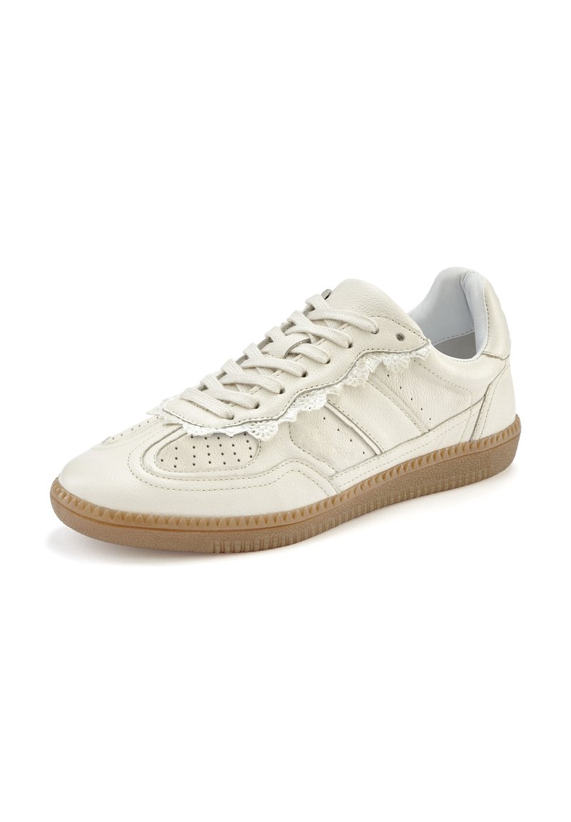 Light beige leather sneaker with a textured surface, perforated detailing, and brown rubber sole. Features flat laces and a padded collar.