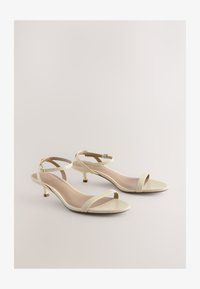 Sélectionné, snake beige