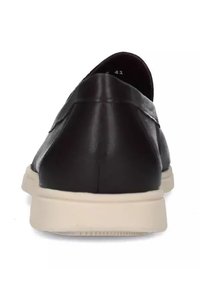 Scarpa nera in pelle senza lacci con finitura liscia, suola in gomma bianca, punta tondeggiante e dettagli di cucitura minimi. La vista posteriore mostra un design elegante.
