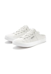 White canvas slip-on shoes with a textured surface, featuring lace-up detailing, round rubber toe cap, and flat white sole.