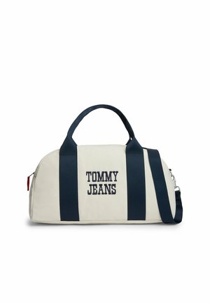 Borsa da viaggio bianca e blu navy con la scritta "TOMMY JEANS" sul davanti, due manici e tracolla regolabile.
