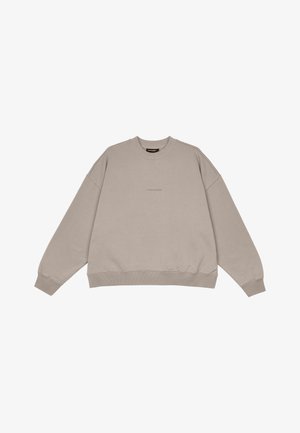 Beige Oversized-Sweatshirt aus weichem Material. Mit Rundhalsausschnitt und gerippten Bündchen sowie Saum. Dezente Branding in der Mitte.