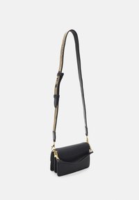 Black leather handbag with a structured design, featuring a gold-accented strap and a front pocket. Smooth texture with a fold-over flap.
