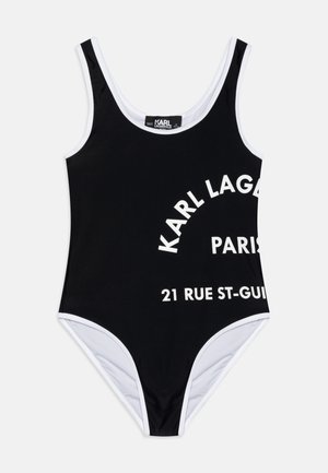 Maillot de bain noir avec des accents blancs mettant en avant un texte audacieux : "KARL LAGERFELD PARIS" et "21 RUE ST-GUIL." Fabriqué en tissu lisse, avec un décolleté plongeant.
