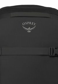 Black backpack by Osprey featuring a sturdy fabric, adjustable strap, embossed logo, and a sleek, minimalistic design.