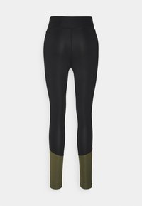 Leggings neri con vita alta, texture liscia e un accent verde ai polsini. Il design enfatizza una vestibilità slim.