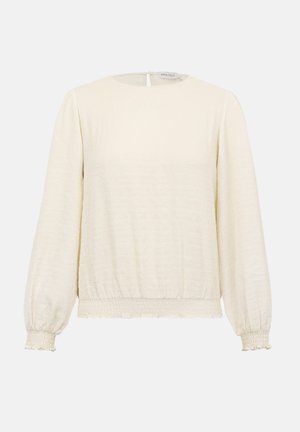 Blouse longue à manches longues couleur crème avec encolure ronde, poignets et ourlet froncés élastiqués, tissu subtilement texturé, et fermeture par boutons au dos.