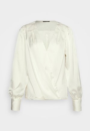 Kremfarvet satinbluse med lange pufærmer, brede manchetter, dyb V-udskæring og slå-om-front.