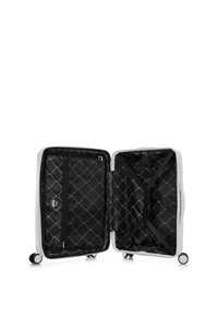 Hard-shell suitcase in white with a textured surface, two wheels, and an interior featuring a black quilted lining and zippered pocket.