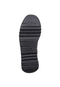 Suela de goma negra con un patrón de relieve texturizado, que incluye la palabra "wonders". Presenta protuberancias para tracción y un diseño de punta redondeada.