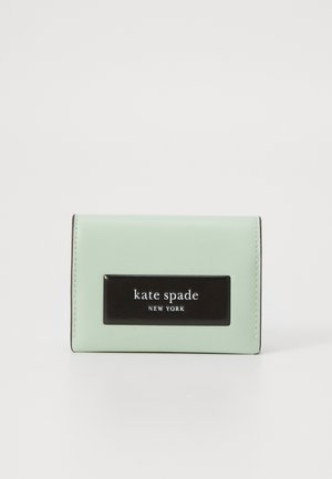 Mint green leather wallet with a black logo plate, rectangular shape, stitched edges, and a smooth texture. Compact and simple design.