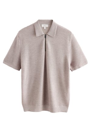 Koszulka polo z krótkim rękawem w jasnobeżowym kolorze z wzorem dzianiny o fakturze, wyposażona w kołnierzyk na zamek błyskawiczny i prążkowany dół.