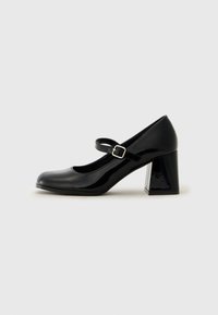 Black patent leather Mary Jane shoe with a rounded toe, adjustable strap, and a chunky rectangular heel. Smooth texture with a shiny finish.