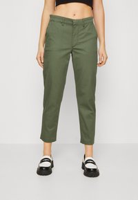 Khaki green, straight-leg pants with a mid-rise waist, featuring front pockets and a clean finish. Paired with black and white loafers.