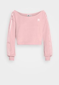 Sweat-shirt rose court en tissu doux, avec un large col, des manches longues et des rayures blanches verticales le long des bras.