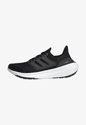 Chaussure de running Adidas Ultraboost noire avec semelle blanche amortie et trois bandes noires sur le côté, vue de profil gauche.