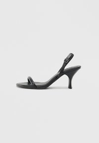 Black leather high-heeled sandals with a slim, curved heel and a crossed strap design. Adjustable ankle strap. Smooth texture.