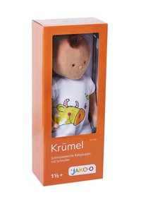 Soft baby doll in orange box, wearing a white shirt with yellow cow pattern. Doll has a round face and short brown hair. Includes pacifier.