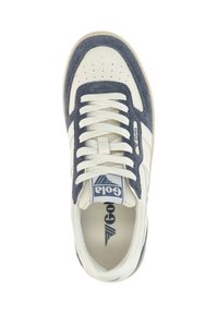White sneaker with navy suede accents, perforated design on toe, white laces, and blue logo detail on tongue. Flat rubber sole.