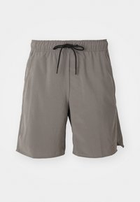 Grå svømmetights med elastisk talje, sort snor, sidelommer og et glat, letvægtsstof. Klassisk knælængde design.