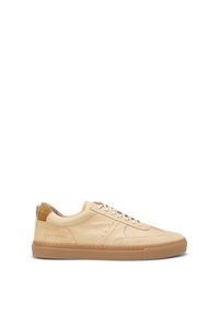 Beige leather low-top sneakers with tonal stitching, rubber outsole, and padded collar. Features lace-up closure and contrasting tan heel tab.