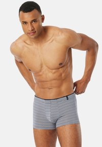 Striped men's boxer briefs in a soft, stretchable fabric. Features navy waistband and horizontal stripes in shades of blue and gray.