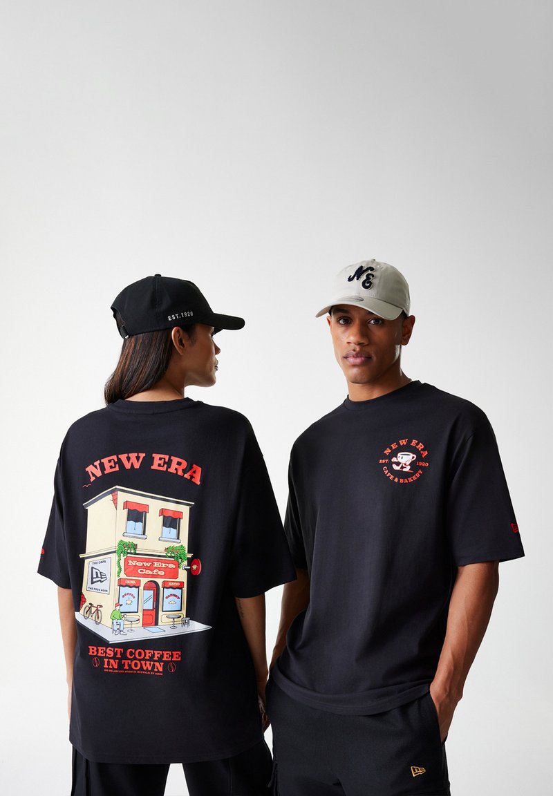 Black t-shirts with graphic designs: one features a café scene, the other has a logo. Caps are black and light grey with embroidered details.