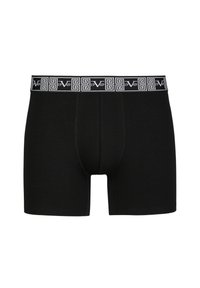 Black cotton boxer shorts with a branded elastic waistband featuring a geometric pattern in white and a year accent. Soft fabric, fitted design.