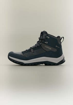 Chaussure de randonnée mi-montante Lowa, bleu canard foncé et grise, avec des lacets, une épaisse semelle intermédiaire blanche et le logo Gore-Tex, vue de profil.