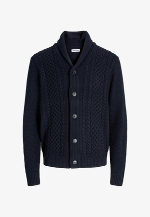 Tumesinine kootud kardigan, millel on kaeluse disain, kabelmustriga kootud tekstuur, viie nööbiga kinnitamine ning soonikkoes mansetid ja allääre. Ühtlane tekstuur kogu ulatuses.